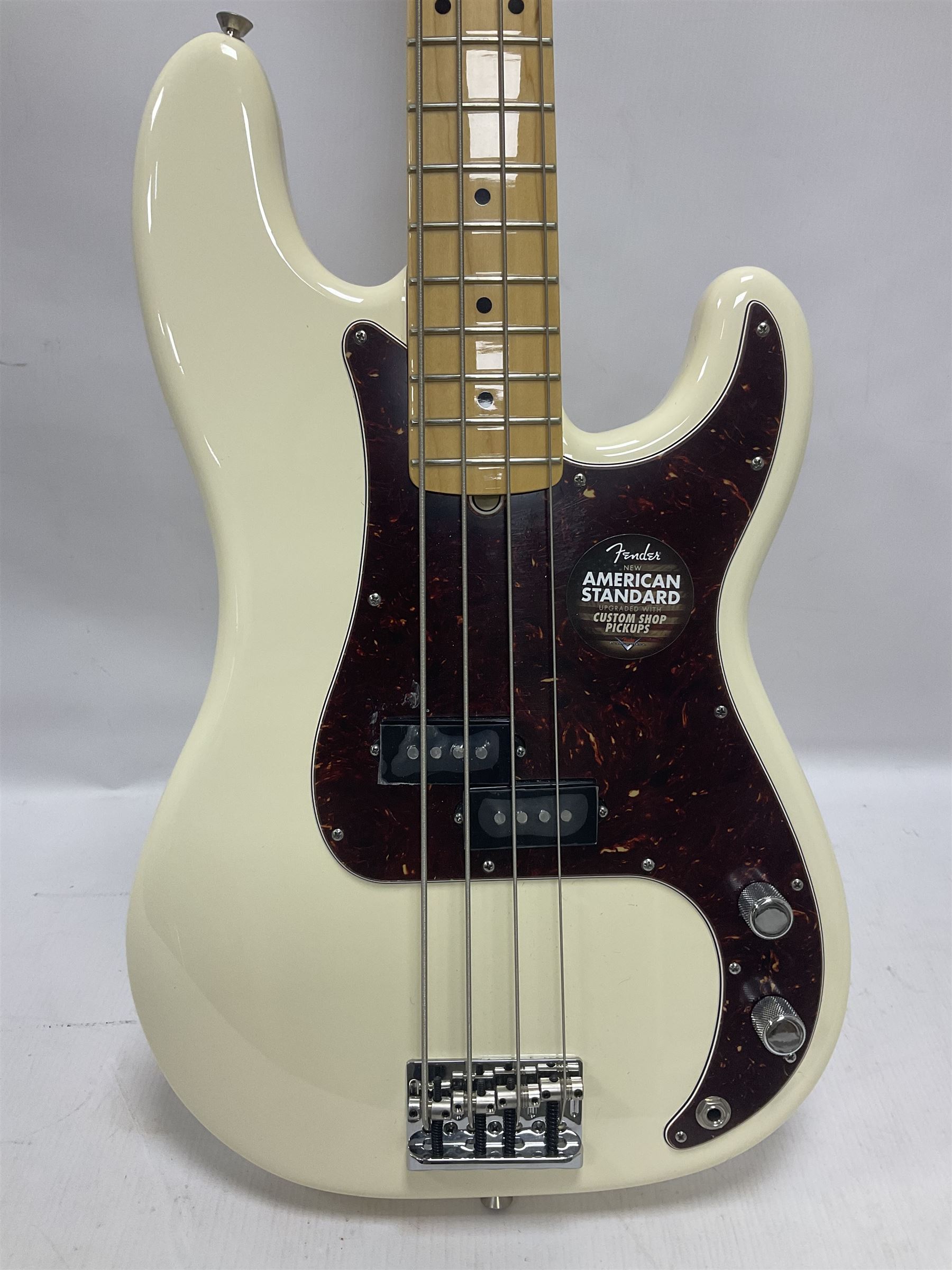 Fender Precision Bass guitar, in Olympic White finish with tortoiseshell effect scratchboard, serial no US15103092, in black Fender hard case with Fender strap and warranty card, guitar L116cm