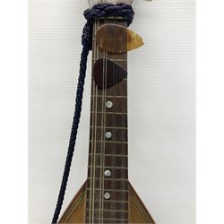 Late 19th/early 20th century Italian lute back mandolin with segmented back and spruce top; bears maker's label for Pietro Tonelli Napoli; together with a mandolin instruction booklet and a folding music stand L60.5cm