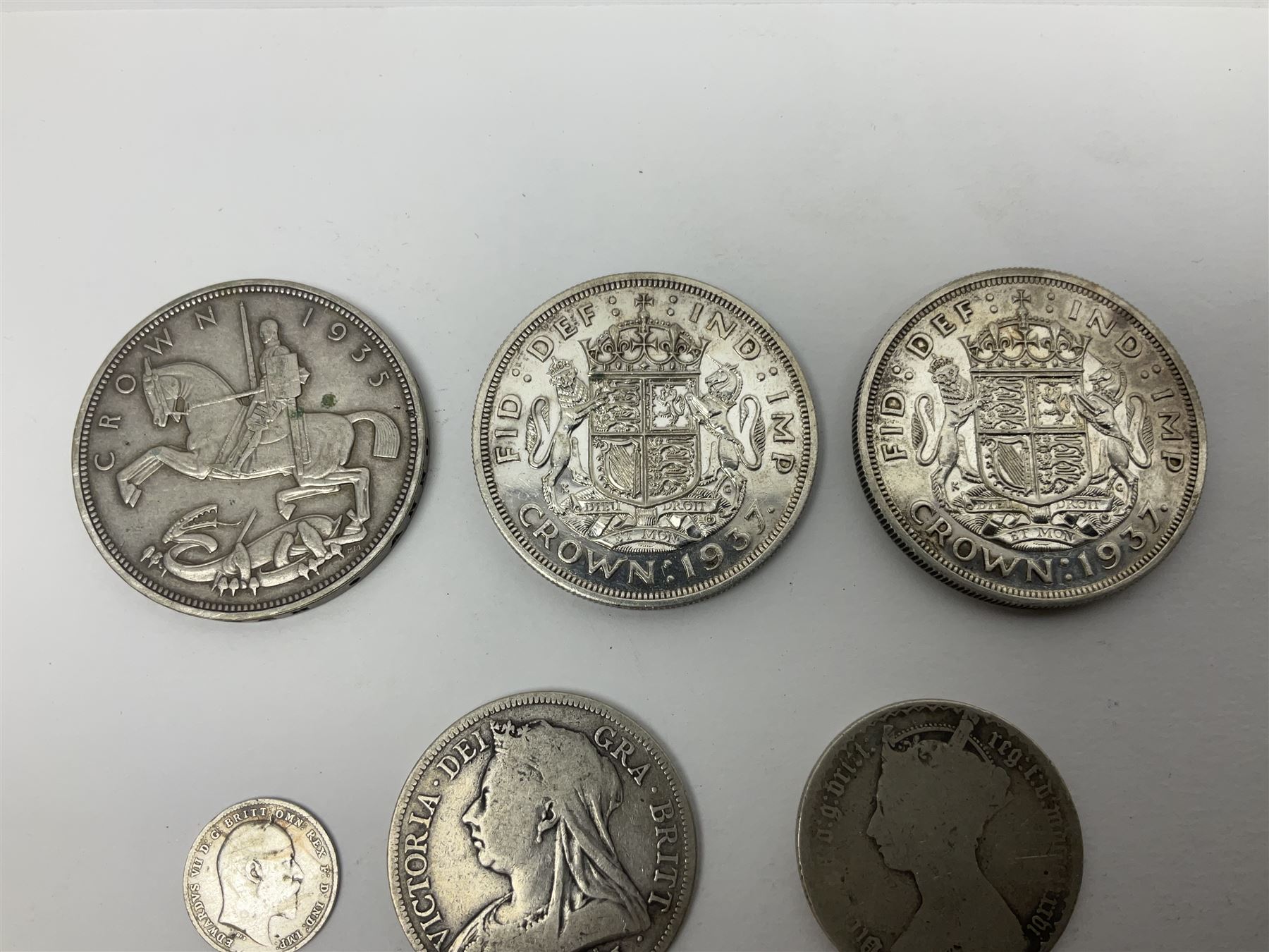 Approximately 65 grams of Great British pre 1920 silver coins and approximately 230 grams of pre 1947 silver coins, including King George V 1935 crown and two King George VI 1937 crowns