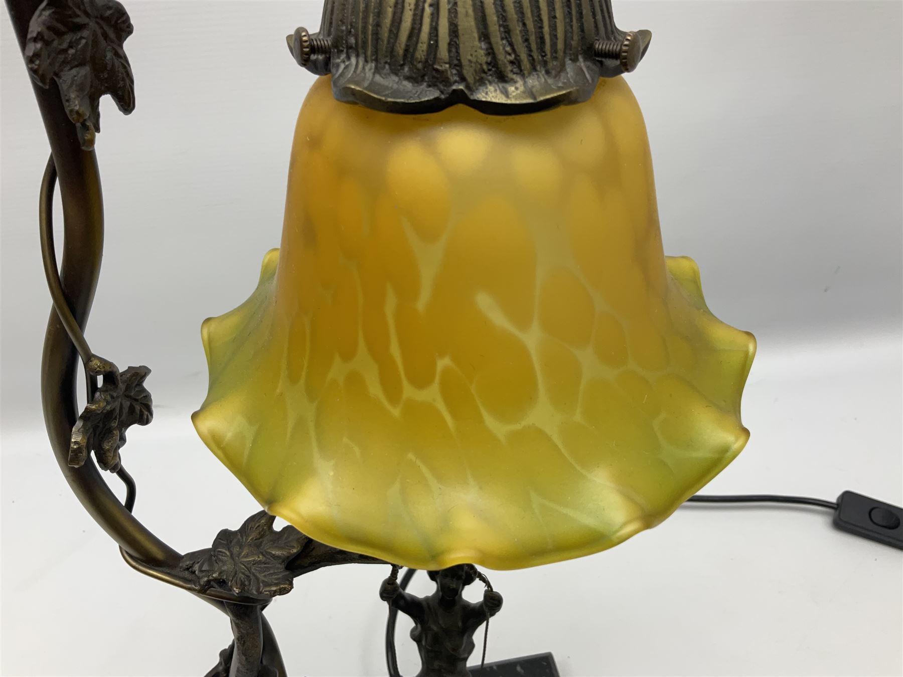 Art Nouveau style lamp in the form of a woman on a swing, with a green mottled shade, upon a marble base H52cm