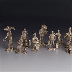 Set of twelve silver place card holders from the 'Cries of London' series, each depicting traditional London street traders, hallmarked Thomas Charles Jarvis, London 1975, tallest H6.5cm