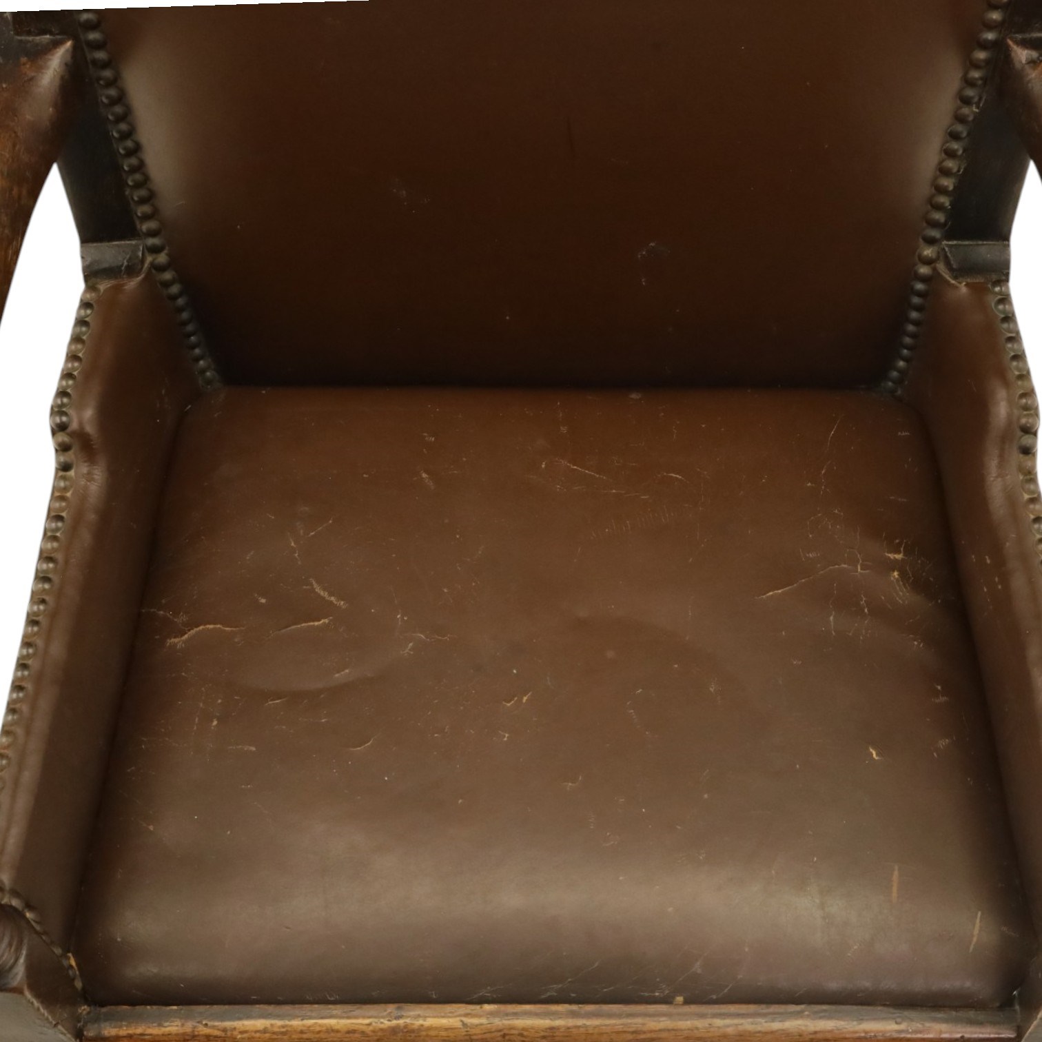 DD CL - Early 20th century oak open armchair, rectangular back with scrolled uprights, brown upholstered back and seat with brass stud edging, shaped open arms on turned supports, square legs united by stretchers