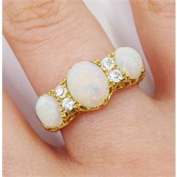 Early 20th century opal and diamond ring, three oval opals with four old cut diamonds set between, stamped 18ct