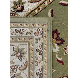 Turkish Sincerity Royale green ground rug, the field decorated with a central floral medallion surrounded by scrolling floral motifs in shades of cream, beige, and burgundy, spandrels filled with matching floral designs, the border featuring a series of floral patterns on a cream ground, finished with green edges