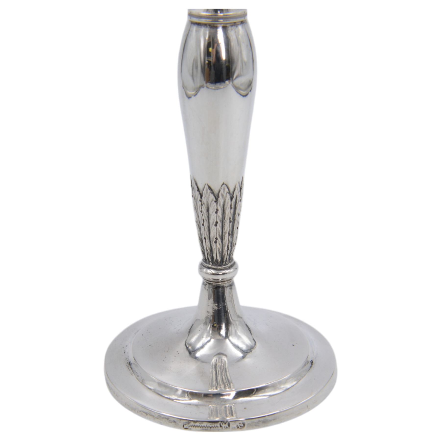 Pair of continental silver candlesticks, probably German Hanau, each of tapering form, with fern leaf decoration, upon a stepped circular base, with Hanau marks and assay scrape to base, H19cm