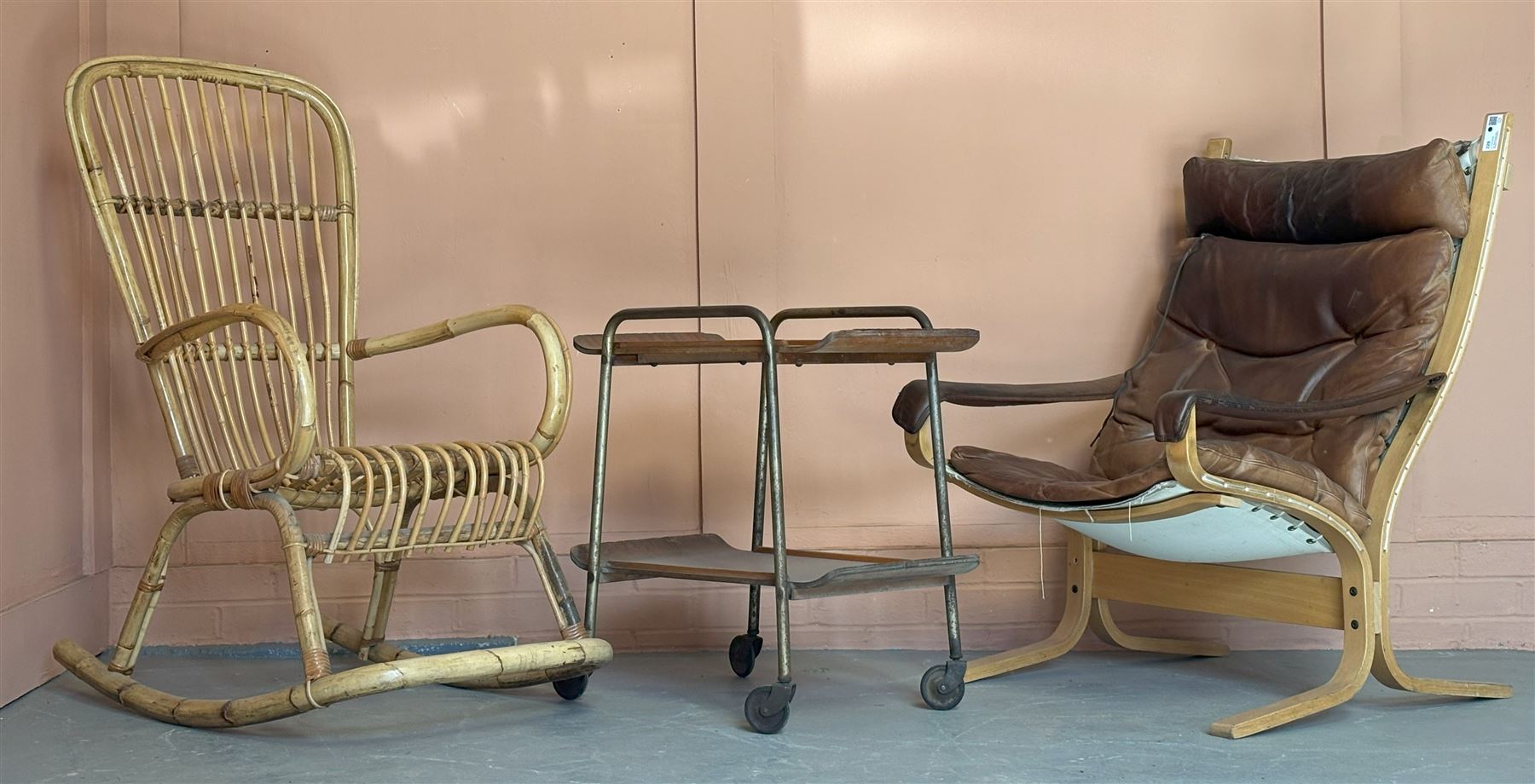 Vintage Norwegian beach framed easy chair with leather covered seat cushion, by Westnova furniture (H99cm) together with a 1950's tubular steel and teak veneered two tier drinks trolley, and a 1970's bamboo rocking chair (3) - COLLECTION BY APPOINTMENT FROM: The White House, Thirsk Road, Easingwold, York, YO61 3NF - CALL 01723 507111 TO ARRANGE