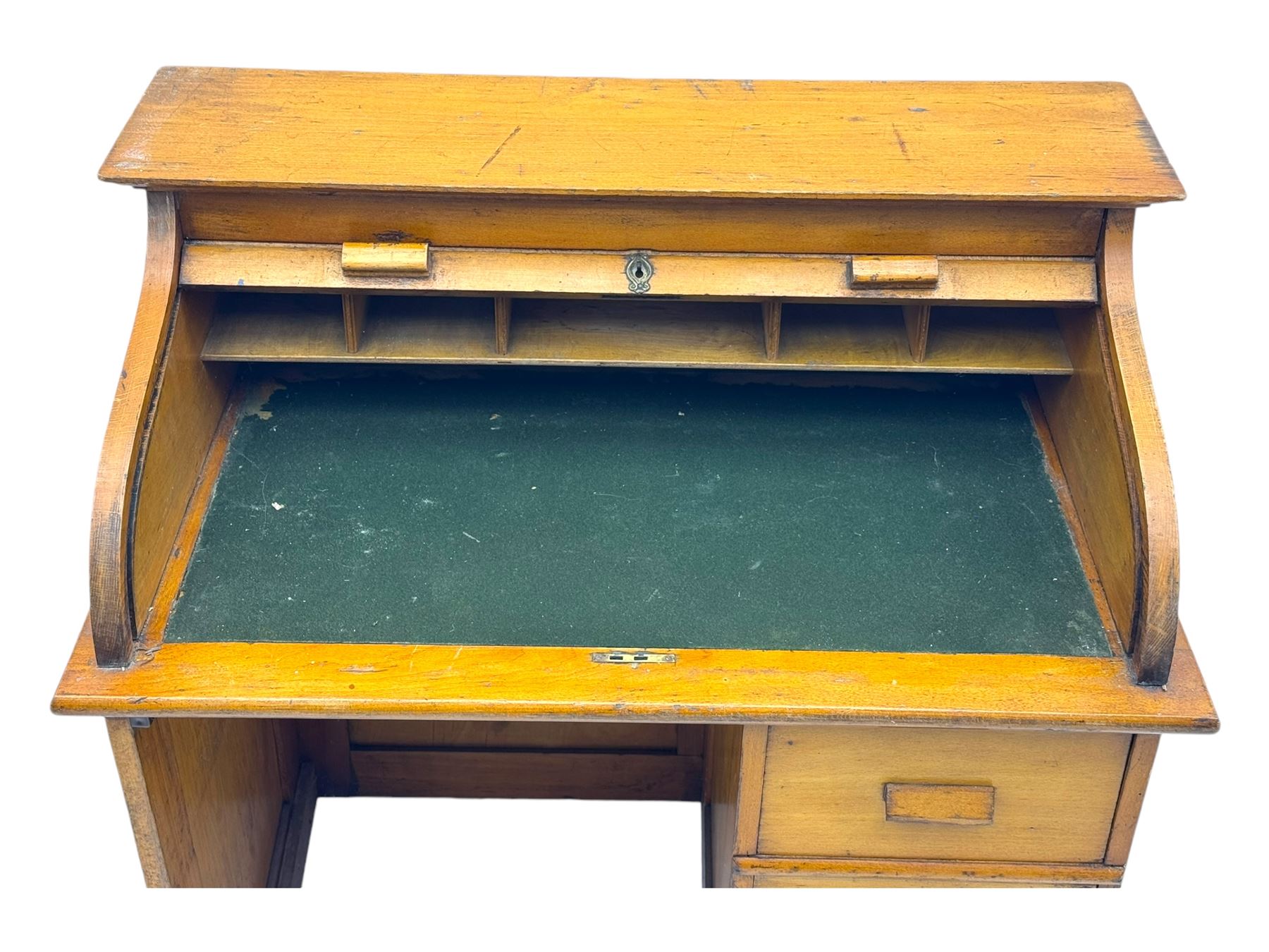 Leeway - late 19th century light oak child's roll-top desk, tambour top opening to reveal fitted interior with green felt writing surface and five pigeonholes, over three graduated drawers on the right side, raised on panelled side supports