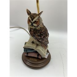 Moulded resin table lamp modelled as an owl perched upon a stack of books with cream tasselled lamp shade, H60cm