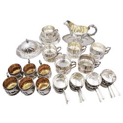 Early 20th century German silver table wares, comprising eleven soup cups and twelve saucers, six chocolate cups, twelve ramekin holders with tapering handles, large sauce boat with fixed stand, a butter dish and cover, and twelve side plates, each with wrythen or lobed detail, all marked with crown and crescent mark, and bearing other marks including 800 or 830, most marked A Roesner Dresden, the sauce boat marked Schnauffer Dresden, soup cups, cholate cups, ramekin holders and butter dish and cover all with ceramic or glass liners, approximate total silver weight 169.8 ozt (5281.8 grams)


