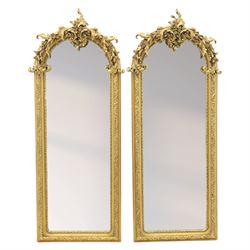 Pair of Louis XV style giltwood overmantel mirrors, the arched rectangular frame surmounte...