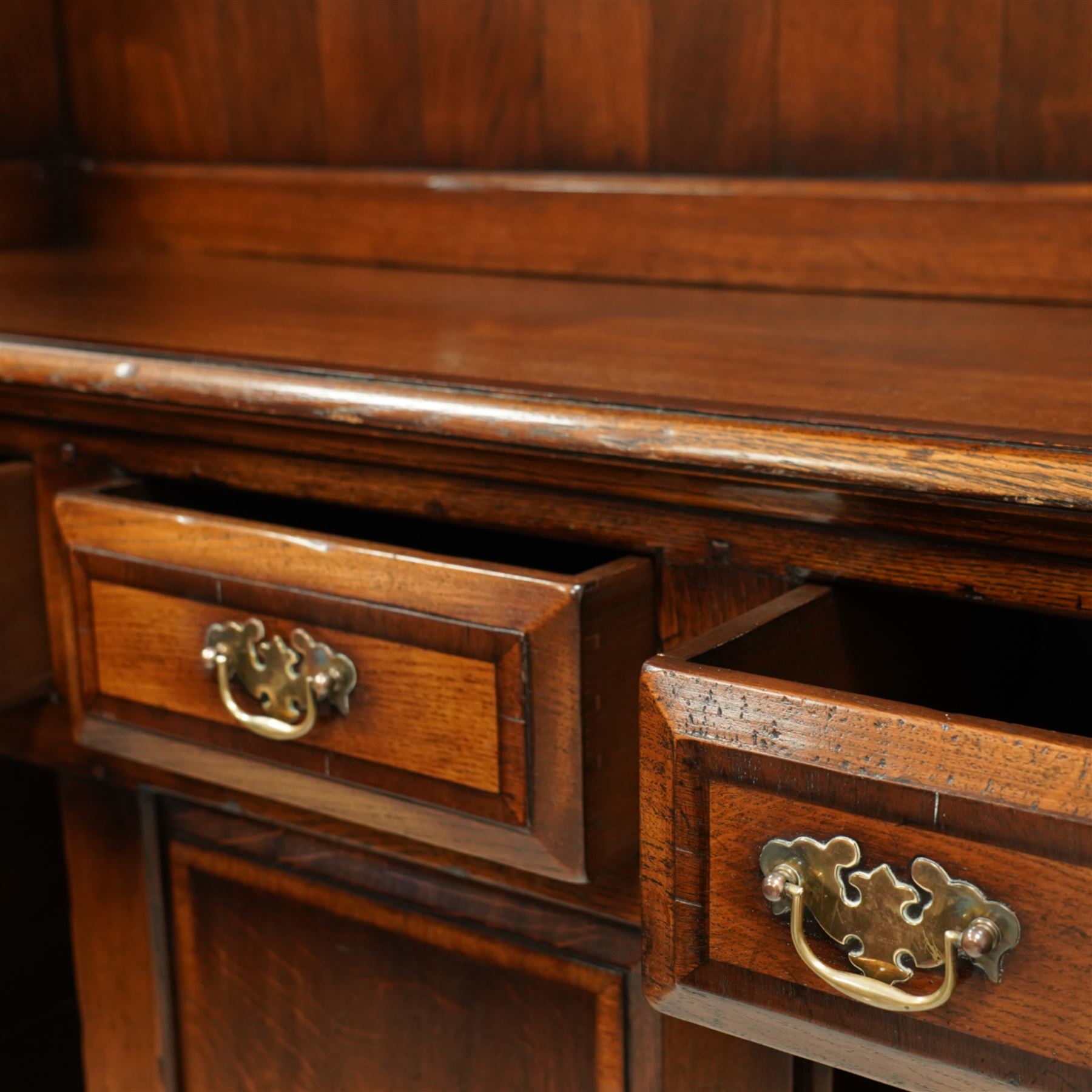 Gostins of Liverpool - Georgian design oak dresser, the two-tier rack with moulded cornice over shaped frieze and end supports, the dresser base with moulded rectangular top over tree drawers and two cupboards, panelled sides, on bracket feet