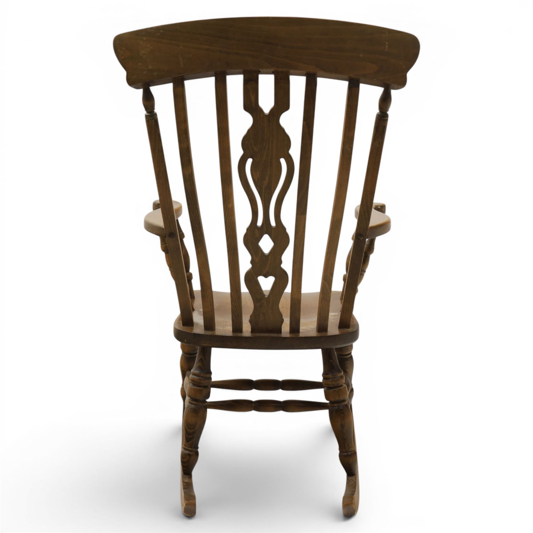 Farmhouse elm rocking chair, high back with 'Fleur De Lis' splat, shaped arms above turned supports, on rocker base 