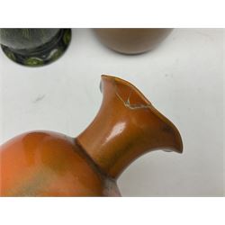 Burmantofts Faience vase, with elongated neck, and concentric circle decoration, in a green lustre glaze, together with a Bretby figure, modelled as a cat with a ball of wool, a Bretby vase, with fluted rim, in orange/red glaze, frog jug and a large West German vase, tallest H38cm