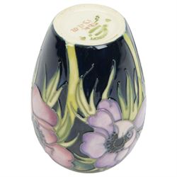 Moorcroft vase in Anemone pattern upon a dark blue ground, marked as a trial piece, impressed and painted marks to base, H14cm 