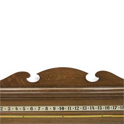 E.J. Riley - 20th century oak billiards scorer, with broken arch pediment with gilt markers mark, with revoling scorer with turned knob, brass indicator, with brass wall hangers