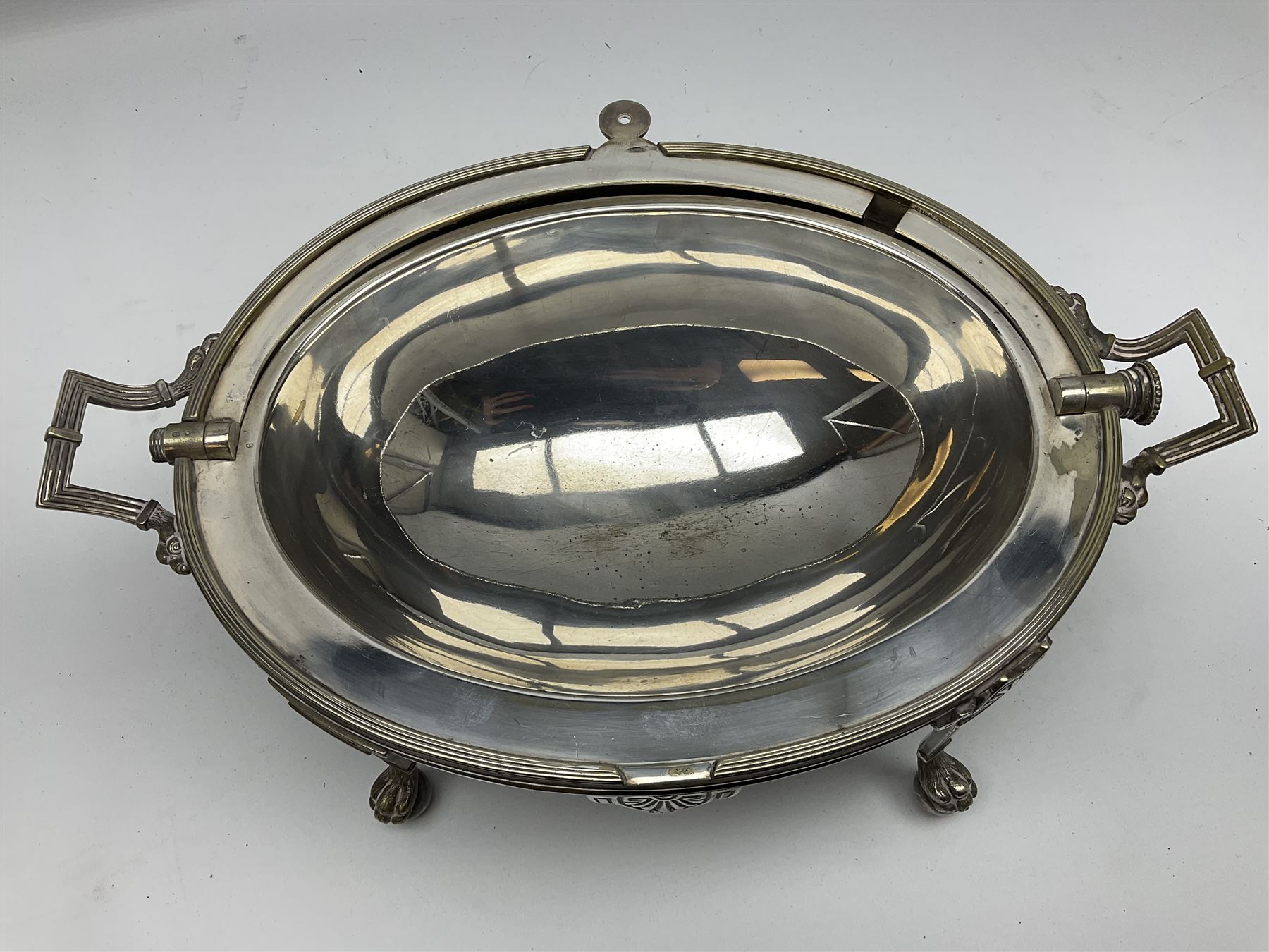 William Hutton & Sons silver plated entree dish, of oval form with twin handles, the revolving top with engraved monogram, upon four claw and ball feet, H22cm 