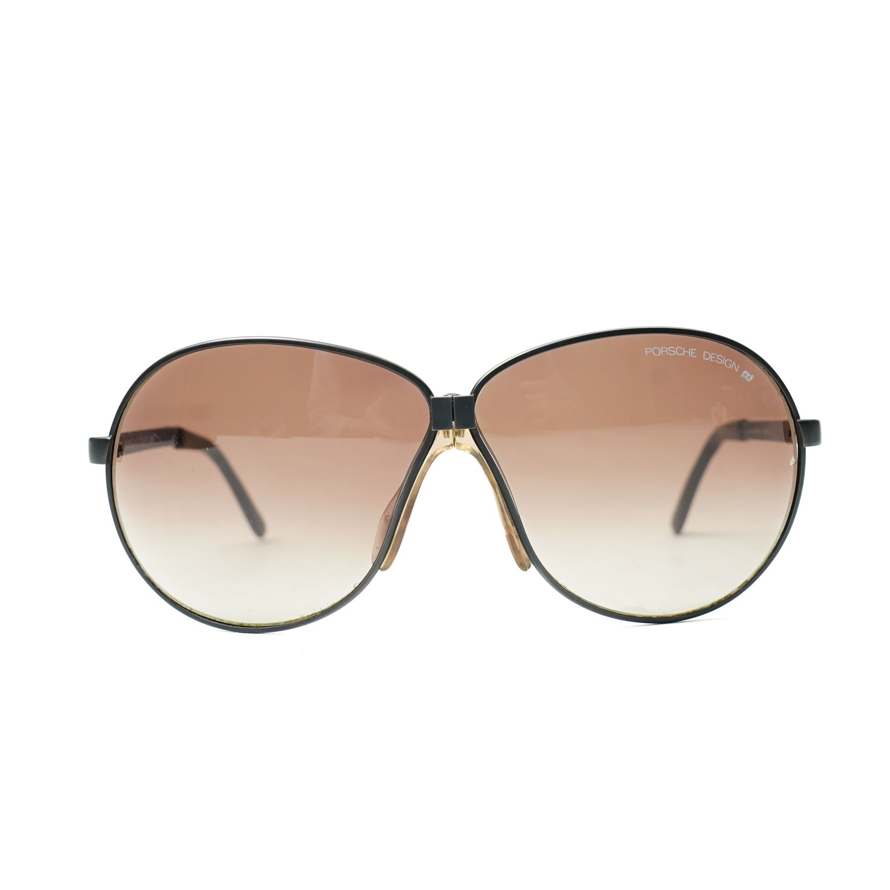 Carrera Porsche Design folding aviator sunglasses, black metal folding frame with brown gradient lenses, double bridge and adjustable nose pads, temples stamped Carrera Porsche Design, together with original Porsche Design case, circa 1980s