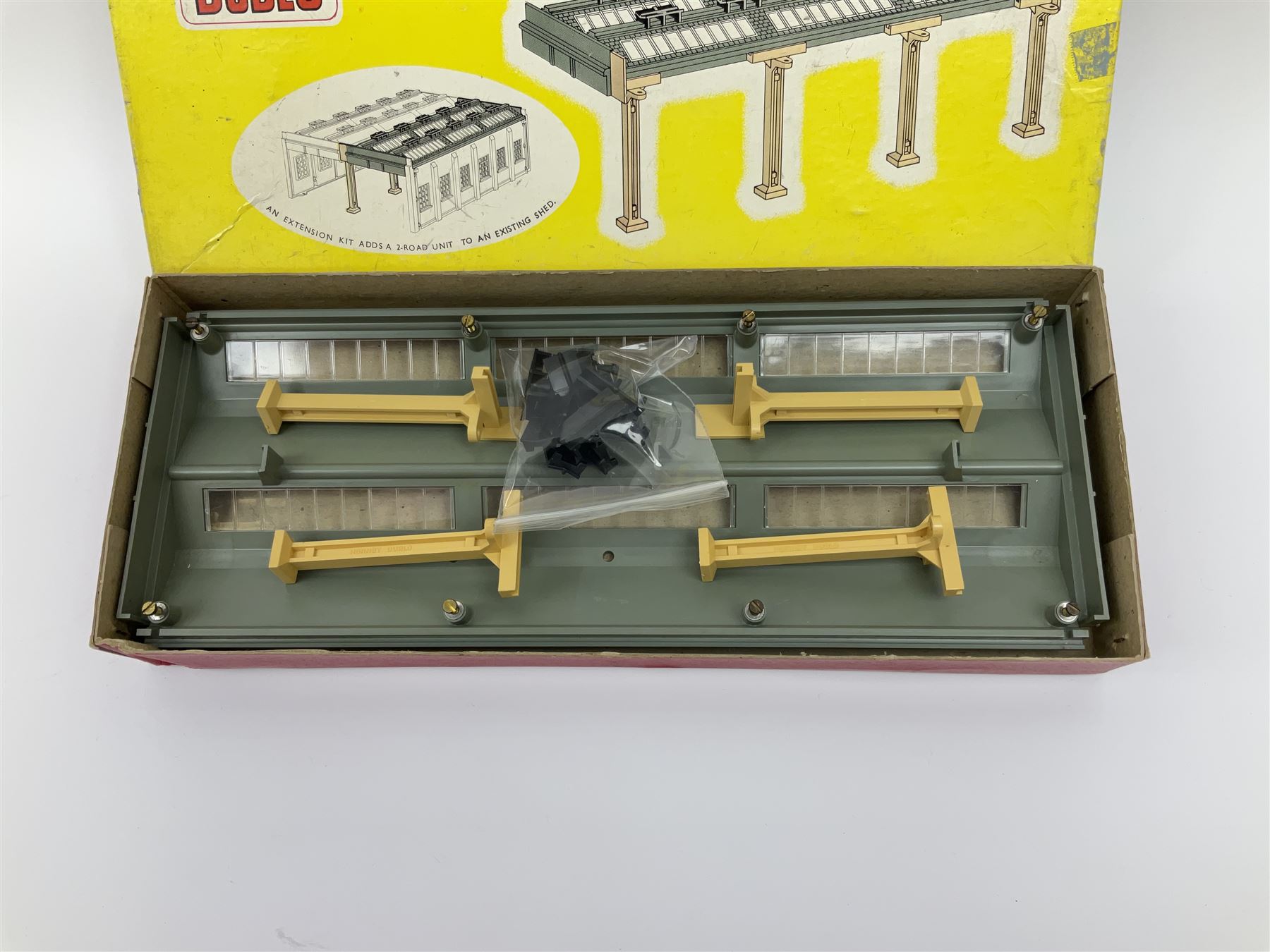 Hornby Dublo - 5006 Engine Shed Extension Kit; 5085 Suburban Station Kit; and 5030 Island Platform Kit; all in pictorial boxes; and Plastic Platform Extension in associated box lid (4)