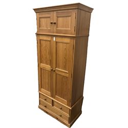 Solid pine double wardrobe, fitted with top box, enclosed by panelled doors, two short and one long drawer, on plinth base 
