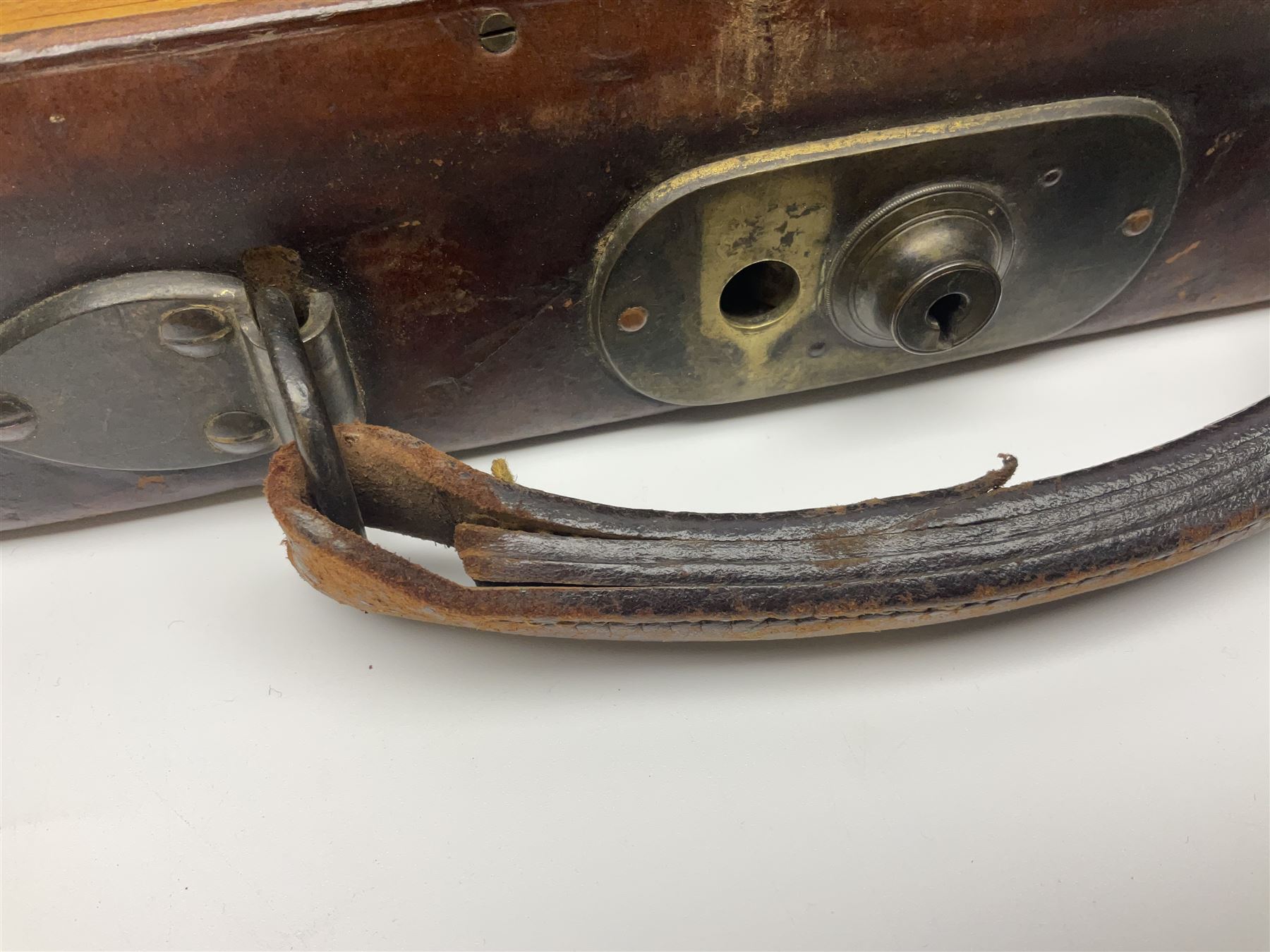 Leather shotgun case, the red baize lined interior with the trade labels of Westley Richards & Co., London, a brass plaque inscribed 'T Nevin, Mirfield, Yorkshire' to cover, with key, case to fit barrel 76cm (30 inches)  
