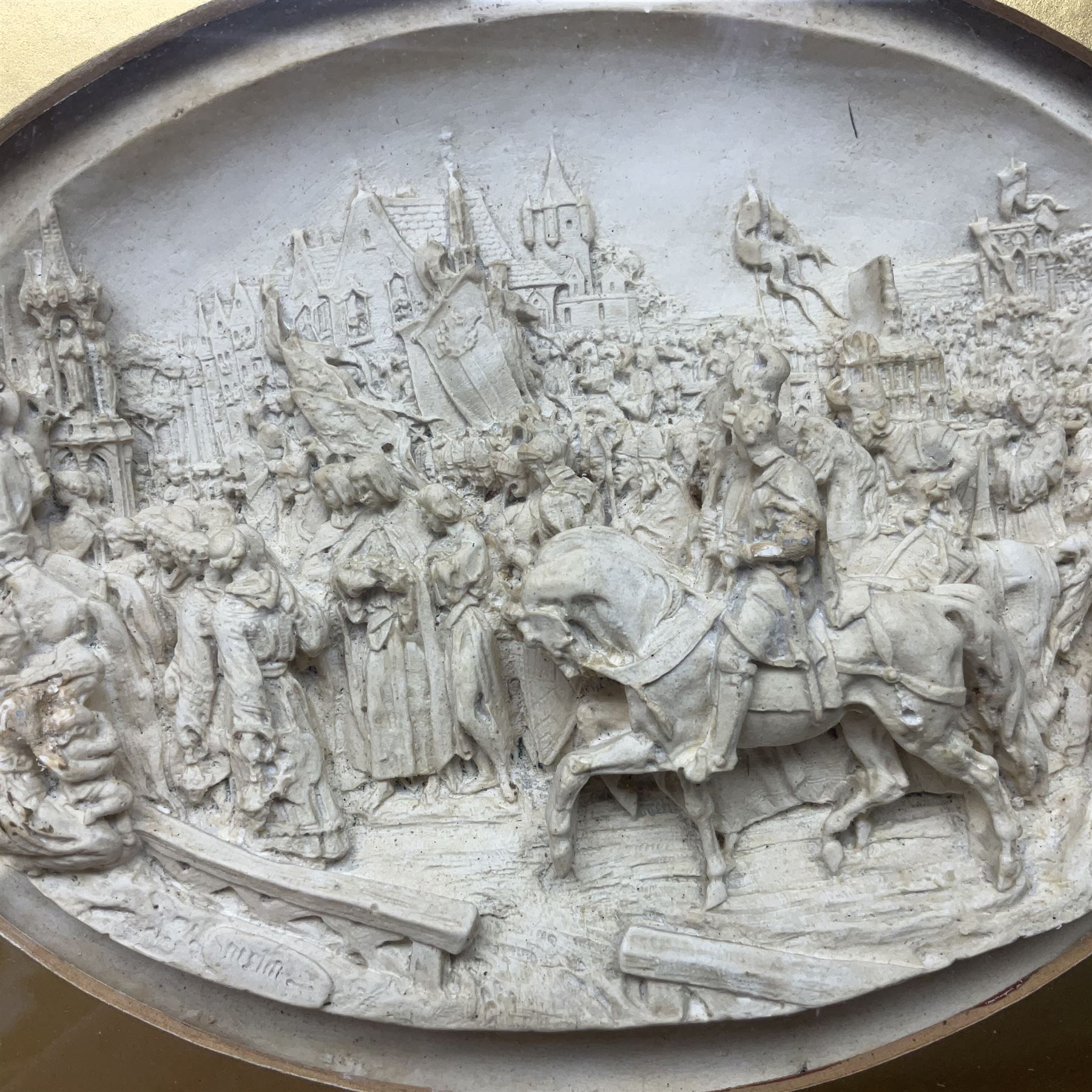 Justin Mathieu, two oval high relief plaque depicting a battle scenes, each within a wooden frame, frame  H21cm, L25cm
