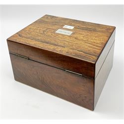 A Victorian rosewood vanity box, with mother of pearl escutcheon and personally engraved plaque to the hinged cover, opening to reveal a velvet and gilt tooled liner and compartmented interior containing a selection  of cut glass bottles and jars, a number with silver plated covers, H17cm L30cm D23cm.  