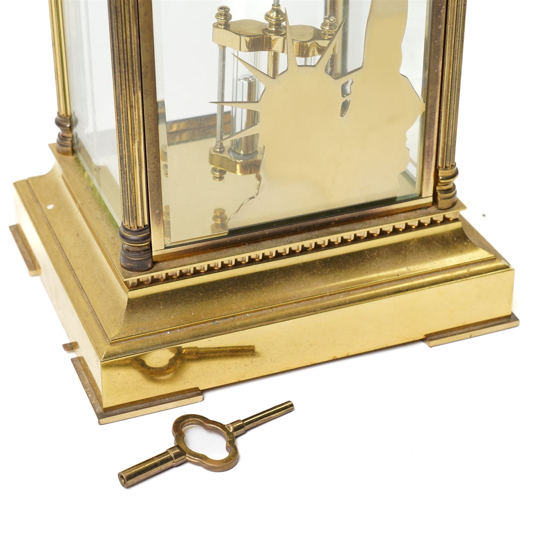 American-20th century Franklin Mint  8-day four-glass mantle clock, brass case with bevelled glass to the doors and sides, with reeded columns and Corinthian capitals to the corners, enamel dial with Roman numerals and five minute Arabic's, with steel moon hands and visible jewelled Brocot escapement, Dial inscribed L' Epee, Liberty Clock, Franklin Mint. No 0906 , with a twin file mercury pendulum and brass silhouette depiction of the Statue of Liberty to the rear of the case, twin train going barrel movement with rack striking.
