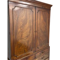 George III mahogany linen press, projecting cornice over two figured doors enclosing five linen slides, the lower section fitted with two short and two long drawers, on bracket feet