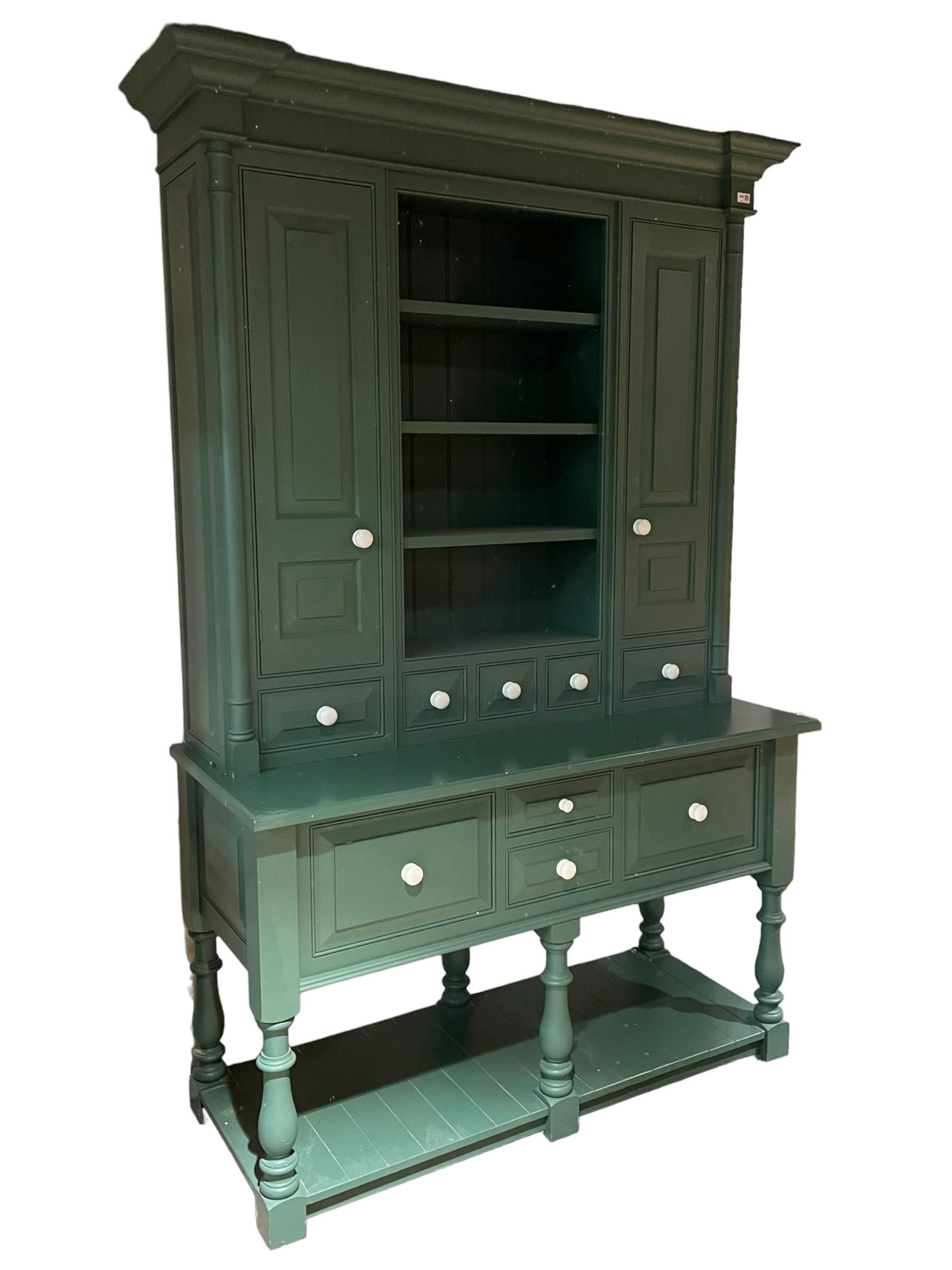 Large contemporary teal green painted kitchen dresser, projecting cornice over three open shelves flanked by cupboard with five spice drawers below, the base fitted with four assorted drawers, raised on turned vasiform supports united by undertier