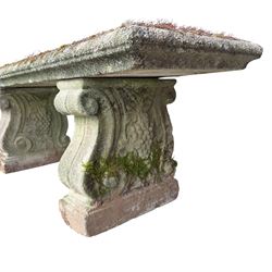 Weathered cast stone three piece bench, the rectangular seat with moulded edge, raised on Neoclassical style end supports with S-scrolls and fruiting grapevines, on rectangular bases