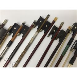 Fourteen predominantly brazilwood violin bows for spares or repair; and a Primavera cello bow; together with a quantity of violin accessories including Matrix SR-1000V tuner; resin/rosin; pitch pipes; bridges; tuning pegs; strings etc