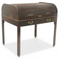 Late 18th century George III mahogany Chippendale design cylindrical roll-top desk carved profusely with geometric and foliate blind-fretwork throughout, the tambour-roll top opening to reveal pigeon holes over an inset red leather writing surface, fitted with two frieze drawers below, raised on square supports with inner chamfer terminating to brass castors, circa 1780s