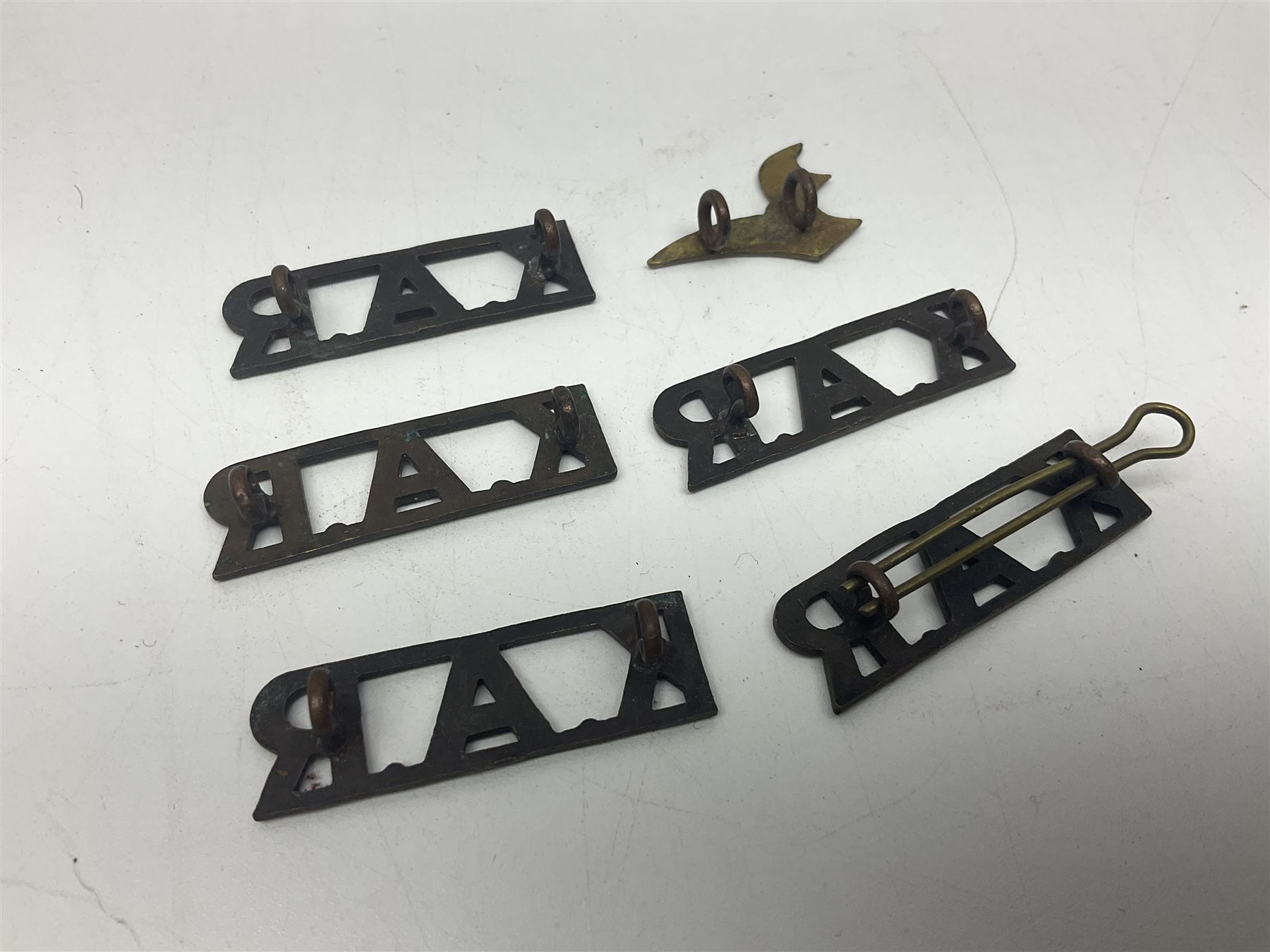 Over thirty British and Continental military metal badges; together with quantity of shoulder titles, collar dogs, rank pips, uniform buttons etc