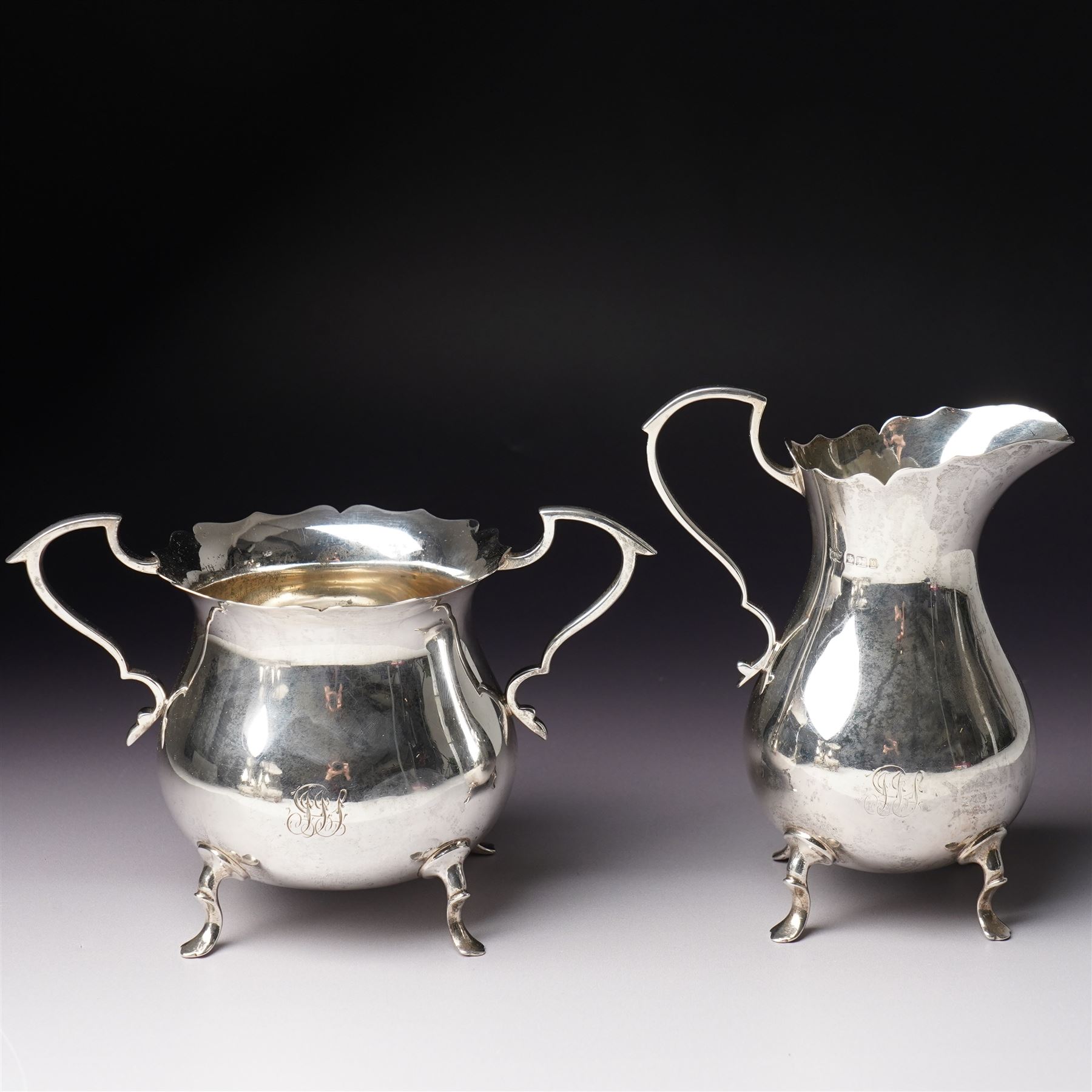 Silver matched five piece tea and coffee set of baluster form engraved with a monogram on shaped supports Sheffield 1913, the teapot 1911, the coffee pot 1924 Maker Mappin & Webb