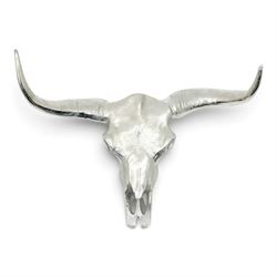 Contemporary cast metal bull skull wall ornament, polished silver finish with textured det...