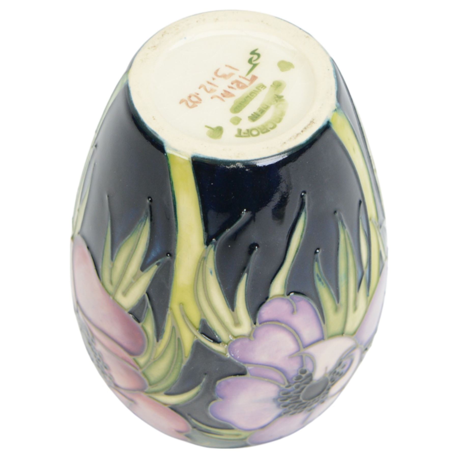 Moorcroft vase in Anemone pattern upon a dark blue ground, marked as a trial piece, impressed and painted marks to base, H14cm 