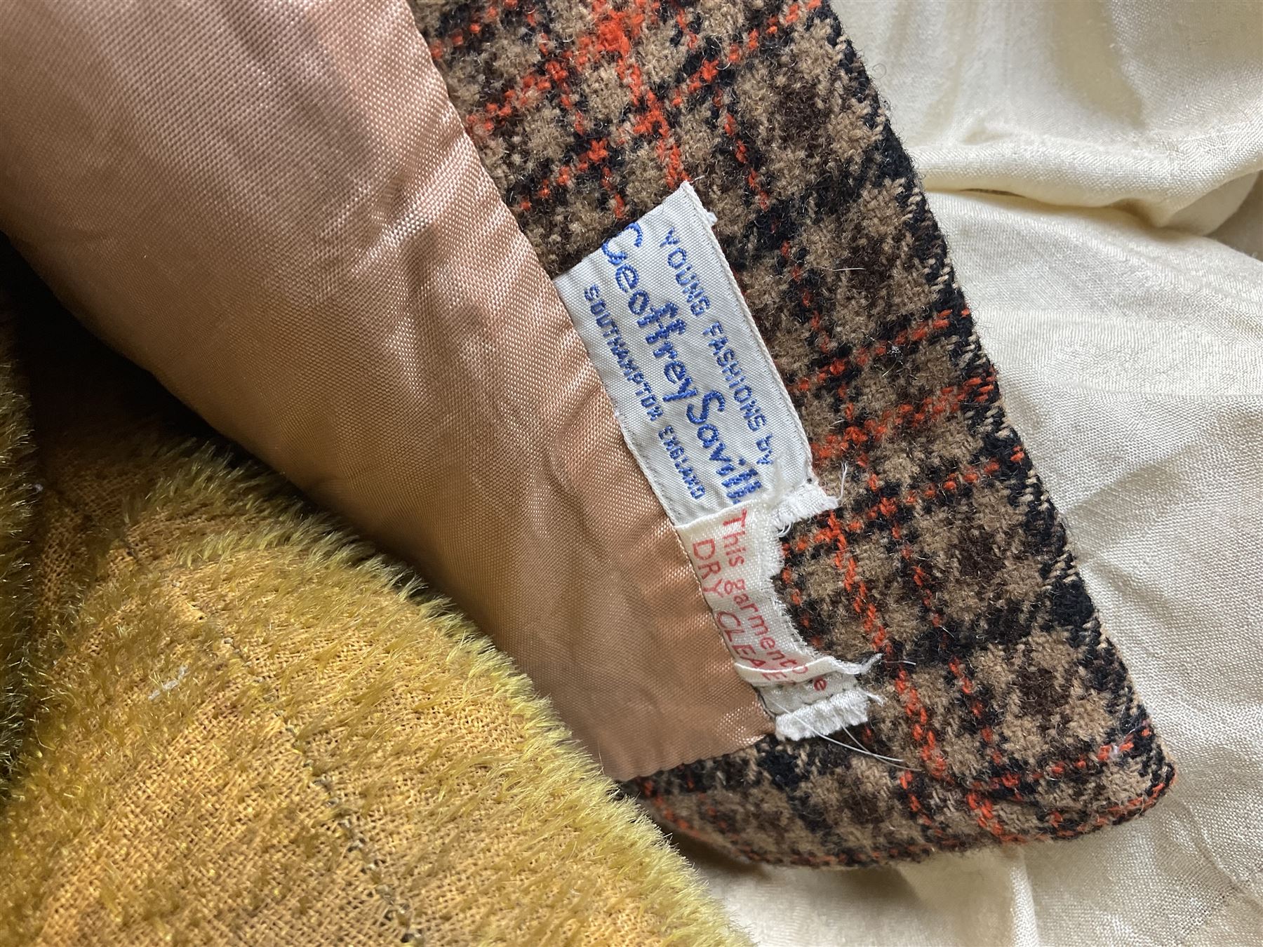 Two early 20th century straw filled jointed teddy bears, first example wearing a tweed jacket bearing Geoffrey Saville label, with leather padded paws and ears, horizontally stitched nose and humpback; second example with applied eyes, vertically stitched nose and faux leather paw pads, both with growler mechanisms, tallest H74cm 