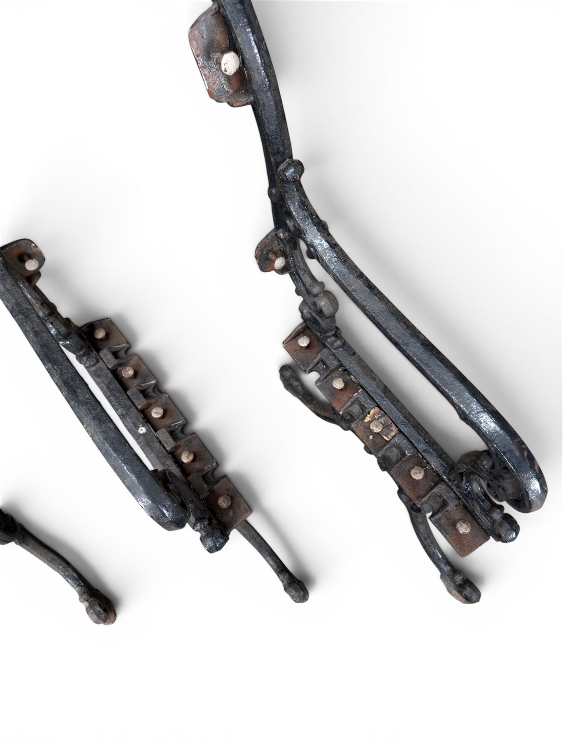 Carron Foundry - two pairs of 19th century cast iron garden bench ends, ornate detail with arms and X shaped legs,finish in black paint, the design no. 110396, first registered 13 July 1857 (see illustration), width as desired