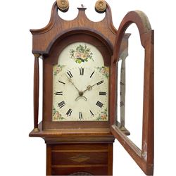 A mid-19th century oak and mahogany longcase clock with a swans neck pediment, brass paterae and a central ball and eagle finial, stepped break arch hood door and flanking waisted pillars with brass capitals, mahogany veneered trunk with canted corners and a short contrasting oak door with applied carving above on a rectangular oak plinth with a shaped base, painted break arch dial, roman numerals and minute markers, matching brass hands with a semi-circular calendar aperture and date disc behind, depiction of a floral bouquet to the break arch and conforming spandrels, dial pinned directly to a 30-hours chain driven movement with countwheel striking, striking the hour on a cast bell. With pendulum and weight
	

