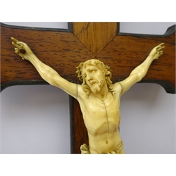  19th century Continental carved sectional Corpus Christi, probably Dieppe, wearing the Crown of Thorns, perizonium tied to his right, mounted on an Rosewood cross with INRI scroll applied above, indistinctly signed, H41cm   