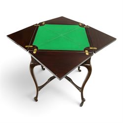 Edwardian carved mahogany envelope card table, the rectangular quadruple hinged top enclosing baize-lined interior, the single frieze drawer and sides with blind-fretwork carving, over cabriole supports with scroll feet and castors united by pierced lattice fretwork X-stretcher with turned finial