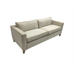Neptune - pair three seat 'Shoreditch' sofas,  upholstered in cream fabric with yellow stringing