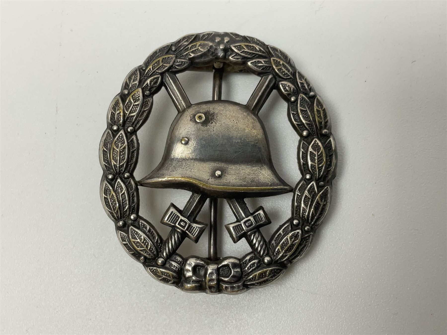 Four German awards - pre-WW2 two-position button hole ribbon for 1914 Iron Cross; WW1 wound badge open back cut-out version with silvered finish; miniature version Mother's Cross with ribbon bow; and The Eastern Medal, officially the Winter Battle in the East 1941–42 Medal (4)