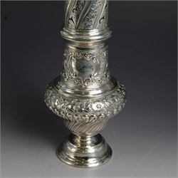 Victorian silver sugar caster, of bellied urn form, embossed with floral and foliate motifs, with two vacant cartouche, upon a domed stepped circular foot, with pierced removable cover with flambe finial, hallmarked Marston & Bayliss, Chester 1900, H25cm