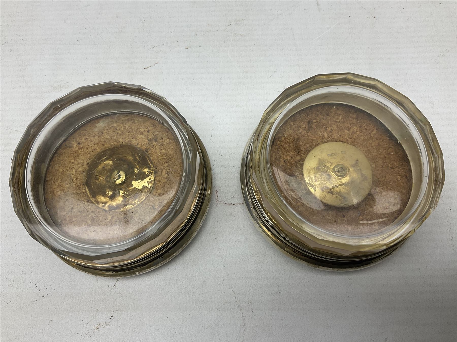 Pair of early 20th century glass dressing table jars, or circular facet cut form, with silver covers, hallmarked London, probably 1912