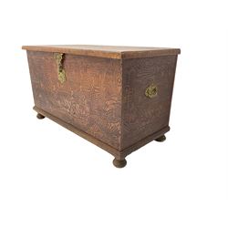 Hong Kong camphor wood chest, rectangular hinged top, carved all over with traditional scenes and dragon boats, on bun feet