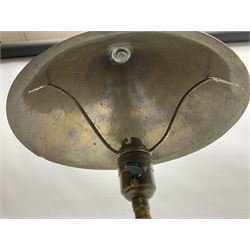 Arts & Crafts Jesson, Birkett & Co, brass table lamp or wall light, designed by Thomas Birkett, the tapering stem with adjustable ball pivot supporting a conical shade with tapering final with ball terminal, upon a circular domed base pierced for wall mounting, shade positioned upright overall H57cm

Often misattributed to Arthur Stansfield Dixon for Birmingham Guild of Handicraft, this particular lamp was designed by Thomas Birkett.
In the late 1890's Birkett worked as a metalwork at the Birmingham Guild, before later joining the Faulkner Bronze Company which went on to become Jesson, Birkett & Co in 1904. The lamp features in lighting catalogues from the firm under the model no E490.

