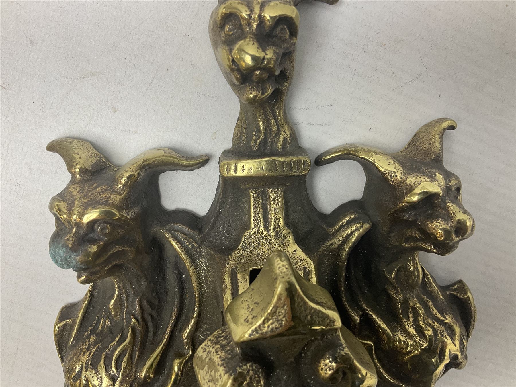 Gothic style cast brass door knocker, modelled with the Greek three-headed hell hound Cerberus on Rococo style base with central knocker of tear drop above Hades, God of the underworld, L29cm