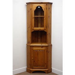  Ducal pine nest of three tables (W53cm, H48cm, D44cm) an oval mirror, CD tower and side cabinet with glass door and single drawer (4)Ducal pine corner cabinet, single arched glazed door with illuminated interior, above cupboard door, on shaped bracket supports, W71cm, H188cm, D44cm  