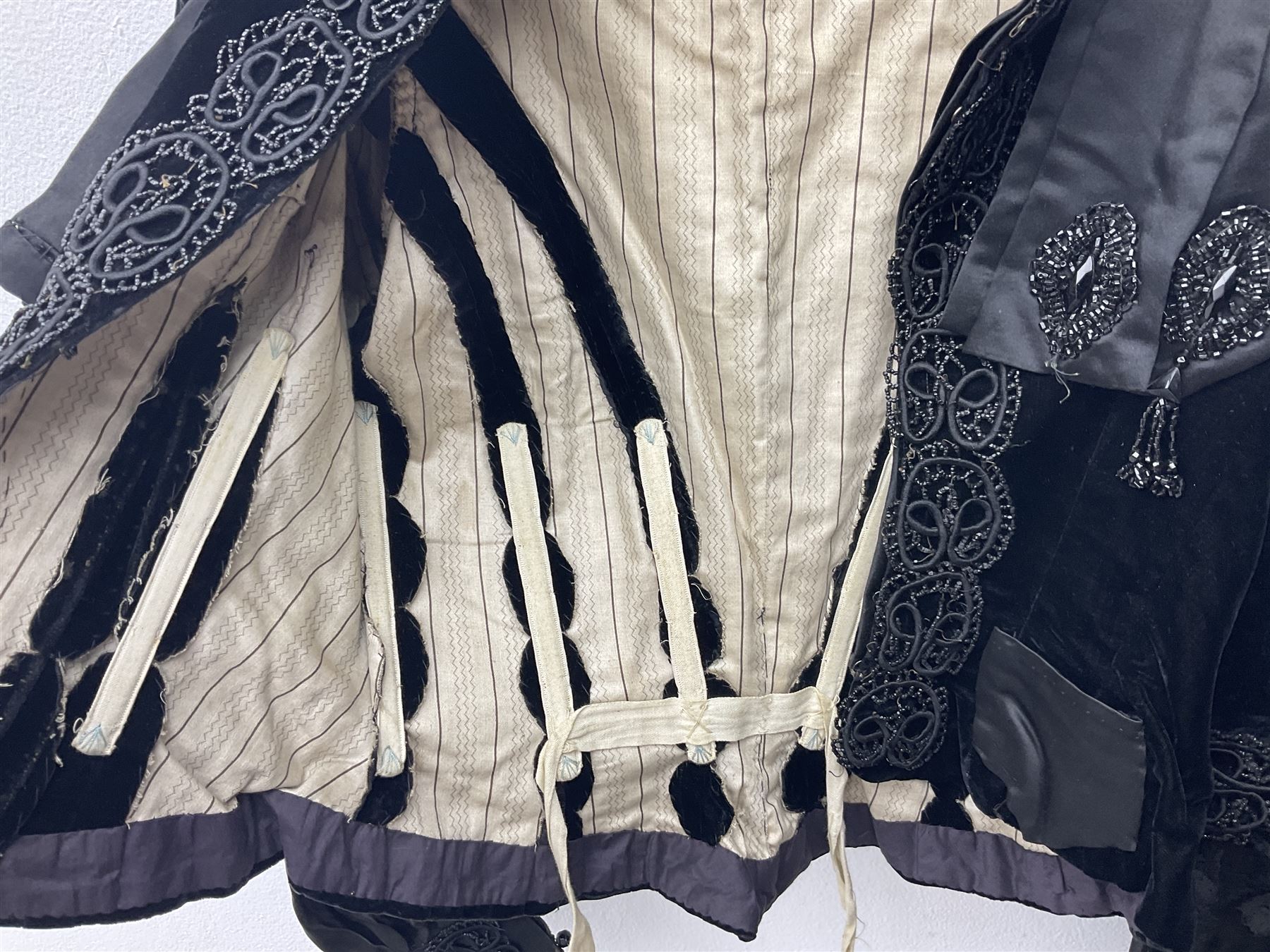 Victorian three piece mourning dress, with lace trim and jet beading, including velvet coat with satin collar panels and cuffs, the nipped waist with boning and slight flared peplum, heavily embellished beaded high neck collar, and ladies embroidered silk lined purse with gilt handle, mount and clasp